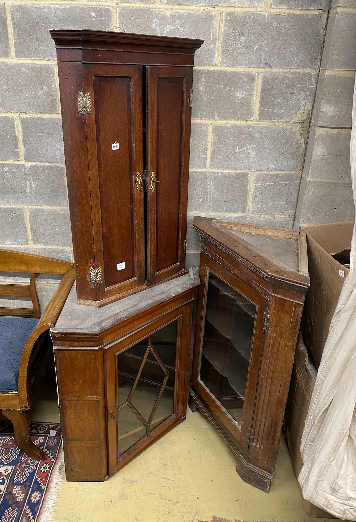 Three George III and later oak and mahogany hanging corner cupboards, largest 80cm, depth 44cm, height 114cm